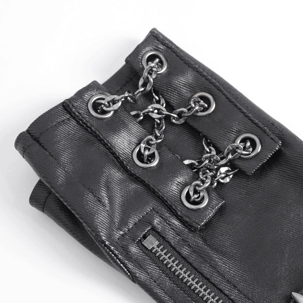 Close-up top view of gothic glove hardware detail showing black textured leather texture with silver chain and eyelet fasteners