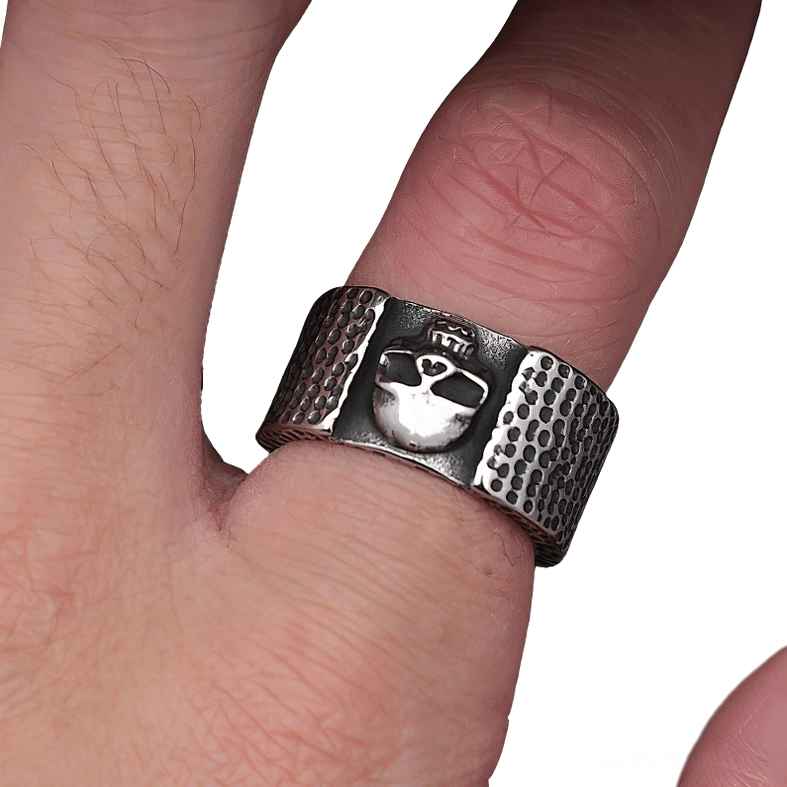 Crowned skull gothic ring on finger close-up showing hammered band design craftsmanship and embossed details vintage patina