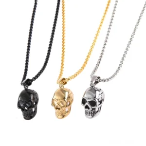 Gothic Totenkopf-Halskette Trio – Schwarze, goldene und silberne Edelstahl-Anhänger mit Box-Ketten im Flat-Lay-Vergleich, komplettes Unisex-Set