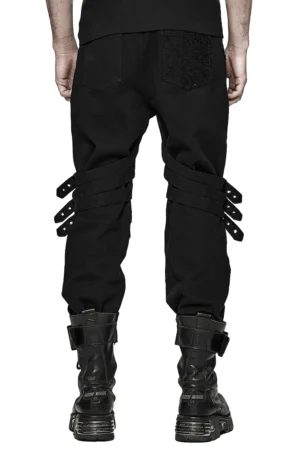 Schwarze Gothic Slim-Fit Röhrenhose mit verstellbaren Schnallenschleifen und strukturiertem Multi-Point-Riemensystem, Rückansicht auf Modell mit Punk-Stiefeln