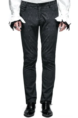 Schwarze gotische Röhrenhose Frontansicht auf männlichem Model, zeigt strukturierte Silhouette mit Reißverschluss-Fly und Jacquard-Webdetail, elegante Herrenhohe Alternative Fashion